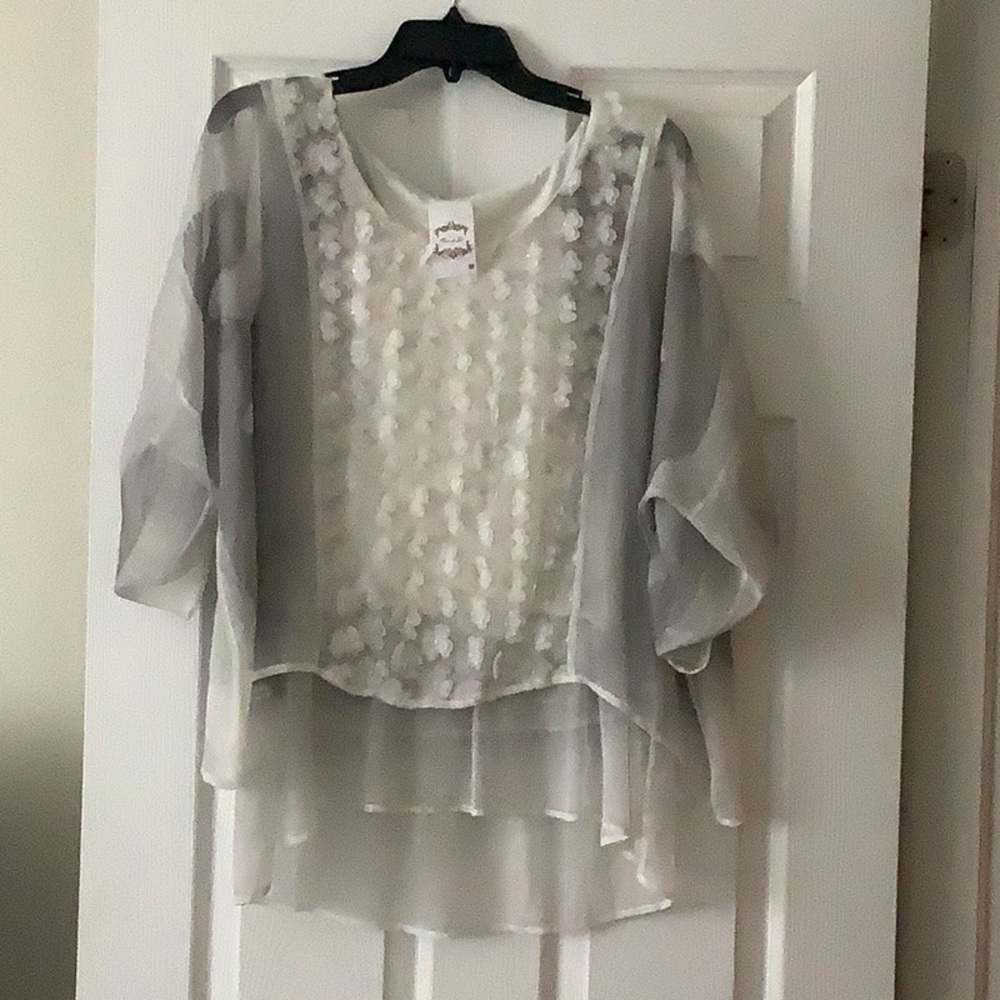 White and gray sheer blouse. Flower petals on the front.